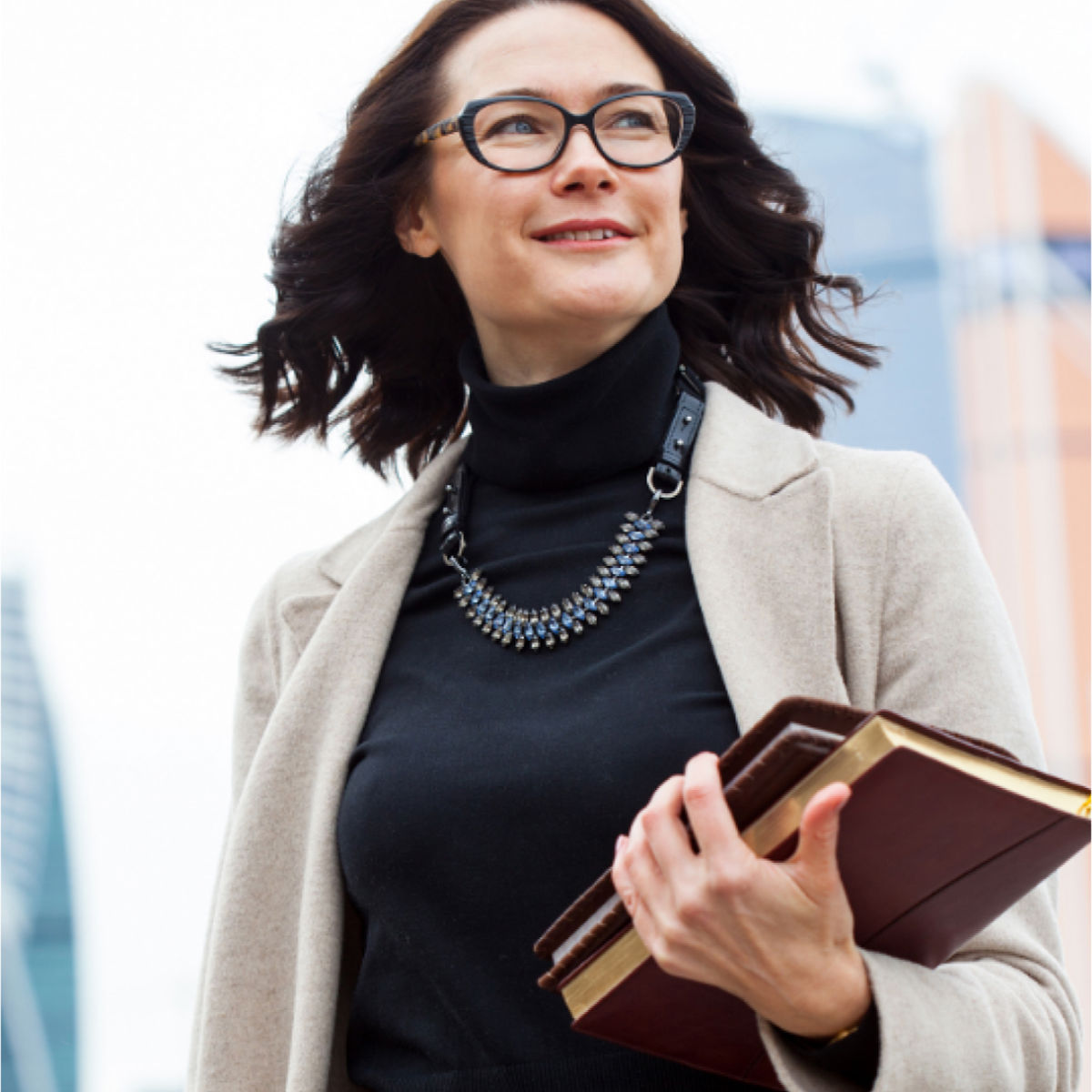 person walking holding book